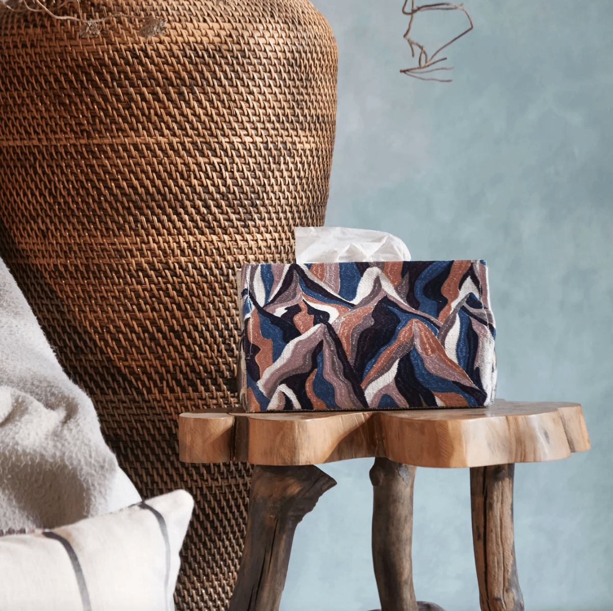 Patterned cushions and a textured throw in a warm, natural interior